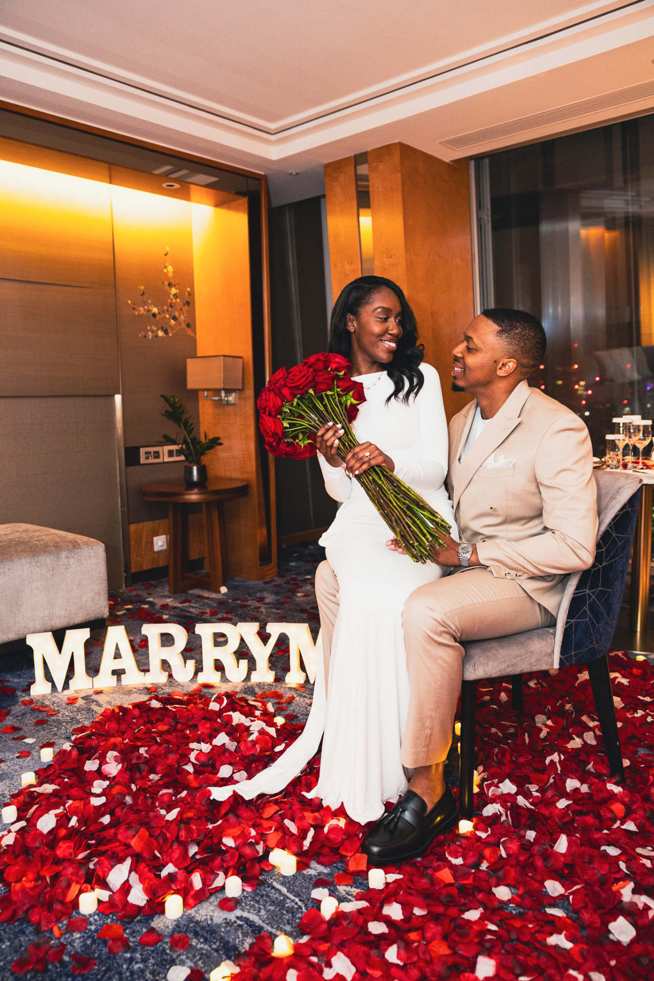 Couple celebrating a luxury hotel proposal in London
